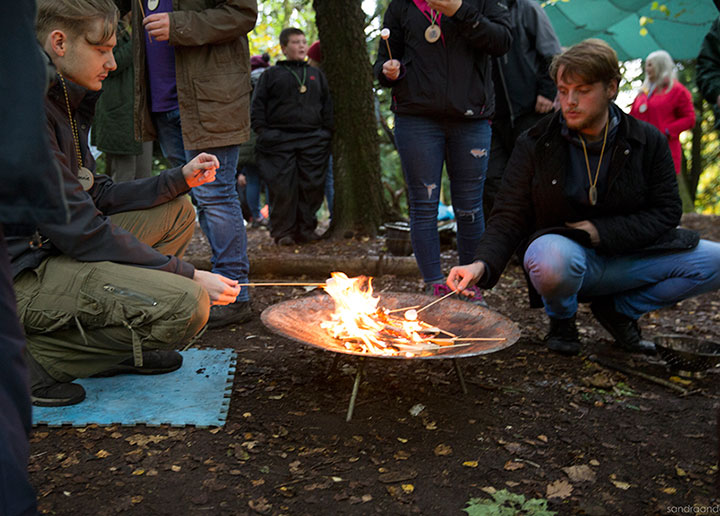Toasting marshmallows over a small fire bowl