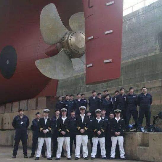 Photo of Royal Navy Engineers underneath HMS Scott  propeller in dry dock